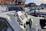 Galeon Galia 770 Sundeck - 2022 Galeon Galia 770 Sundeck helm with marina view in background.