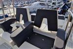 Galeon Galia 770 Sundeck - 2022 Galeon Galia 770 Sundeck boat interior with black seating at marina.