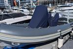 Highfield DL 540 - 2019 Highfield DL 540 inflatable boat docked at a marina, covered seats, surrounded by other boats.