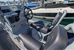Highfield DL 540 - 2019 Highfield DL 540 boat interior with steering wheel and seating at a marina.
