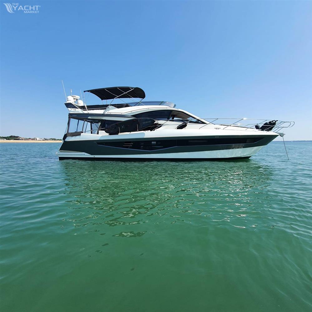 Galeon 550 Fly - 2017 Galeon 550 Fly yacht on calm water under clear blue sky.
