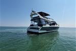 Galeon 550 Fly - 2017 Galeon 550 Fly yacht on calm water under clear blue sky.