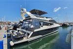 Galeon 550 Fly - 2017 Galeon 550 Fly yacht docked at marina under clear blue sky.