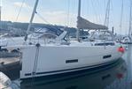 Dufour 390 - 2021 Dufour 390 sailboat docked in a marina, featuring sleek design and modern amenities.