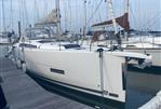 Dufour 390 - 2021 Dufour 390 yacht docked at marina, featuring sleek design and modern sails.