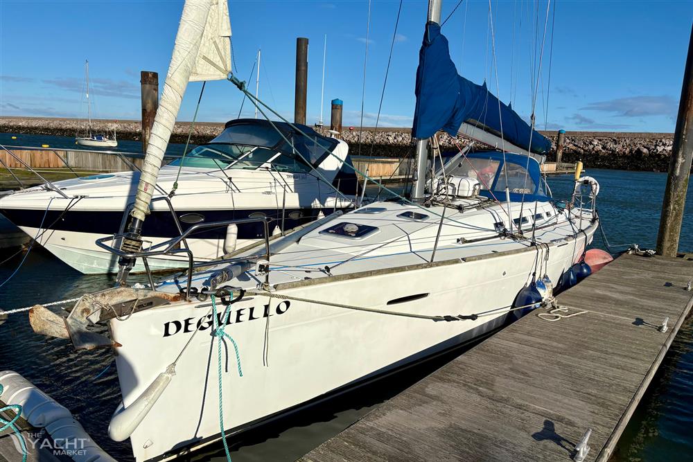 Beneteau First 40 - Sailboat Beneteau First 40, 2011 model, docked at marina under clear blue sky.
