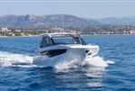 Galeon 335 GTO - 2025 Galeon 335 GTO yacht cruising on blue waters with scenic mountain backdrop.