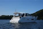 Sealine SC42 - 2013 Sealine SC42 yacht cruising on a serene lake with lush green hills.
