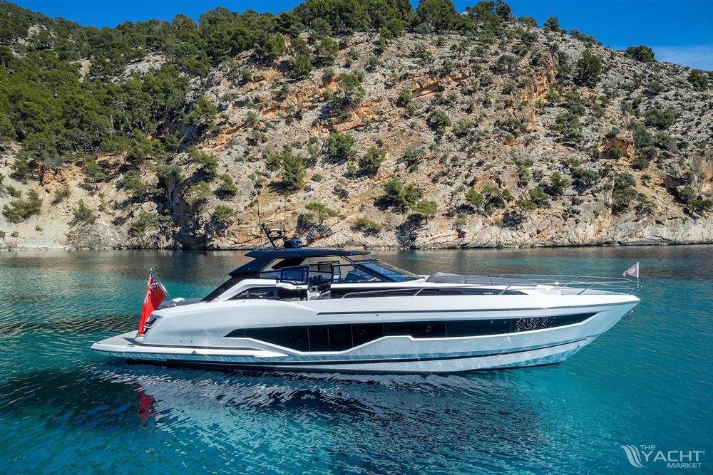 Sunseeker Superhawk 55 - 2024 Sunseeker Superhawk 55 yacht cruising near rocky coastline.
