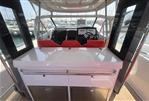 Nimbus T11 T-TOP - 2022 Nimbus T11 T-TOP boat interior with red seats and navigation equipment.