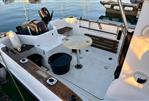 Quicksilver 640 Pilothouse - 2008 Quicksilver 640 Pilothouse boat interior with seating, table, and motor.