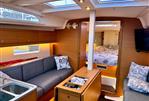 Dufour 37 - Modern interior of 2023 Dufour 37 yacht with cozy seating and elegant wood finish.
