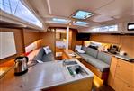 Dufour 37 - Modern interior of 2023 Dufour 37 yacht with cozy seating and kitchenette.