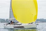 Dufour 37 - 2023 Dufour 37 sailboat with a vibrant yellow spinnaker on the water.