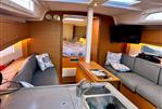 Dufour 37 - Interior of 2023 Dufour 37 yacht with modern kitchen and cozy seating area.