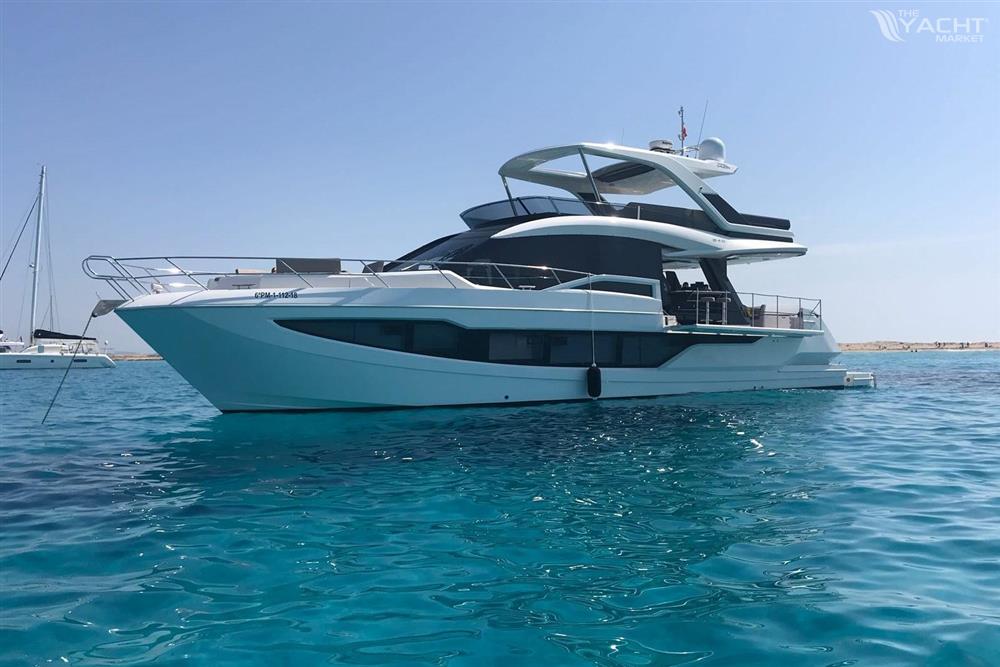 Galeon 640 Fly - 2018 Galeon 640 Fly yacht on clear blue water, showcasing sleek design and luxury features.
