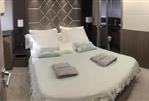 Galeon 640 Fly - Luxurious bedroom interior on 2018 Galeon 640 Fly yacht with elegant bedding and decor.