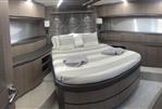 Galeon 640 Fly - Luxurious bedroom interior of 2018 Galeon 640 Fly yacht with modern design and cozy bedding.