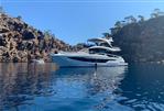 Galeon 640 Fly - Luxurious 2018 Galeon 640 Fly yacht anchored in scenic rocky bay.