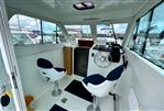 Starfisher 670 - Interior of 2001 Starfisher 670 boat with helm, two seats, and marina view.