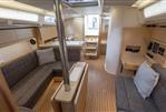 Hanse 388 - Cozy cabin interior of 2021 Hanse 388 yacht with soft lighting and striped pillows.