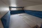 Sealine S34 - 2004 Sealine S34 yacht interior cabin with blue upholstery and white mattress.