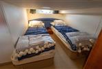 Princess V42 - Twin cabin in 2000 Princess V42 yacht with cozy bedding and nautical decor.