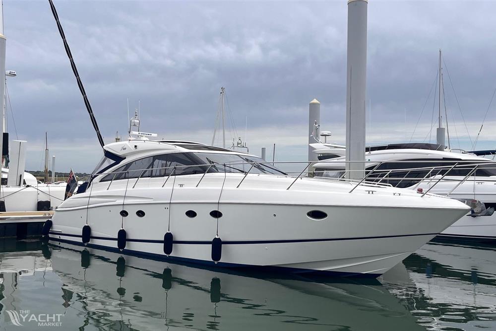 Princess V53 - Luxury 2006 Princess V53 yacht docked at marina under cloudy sky.