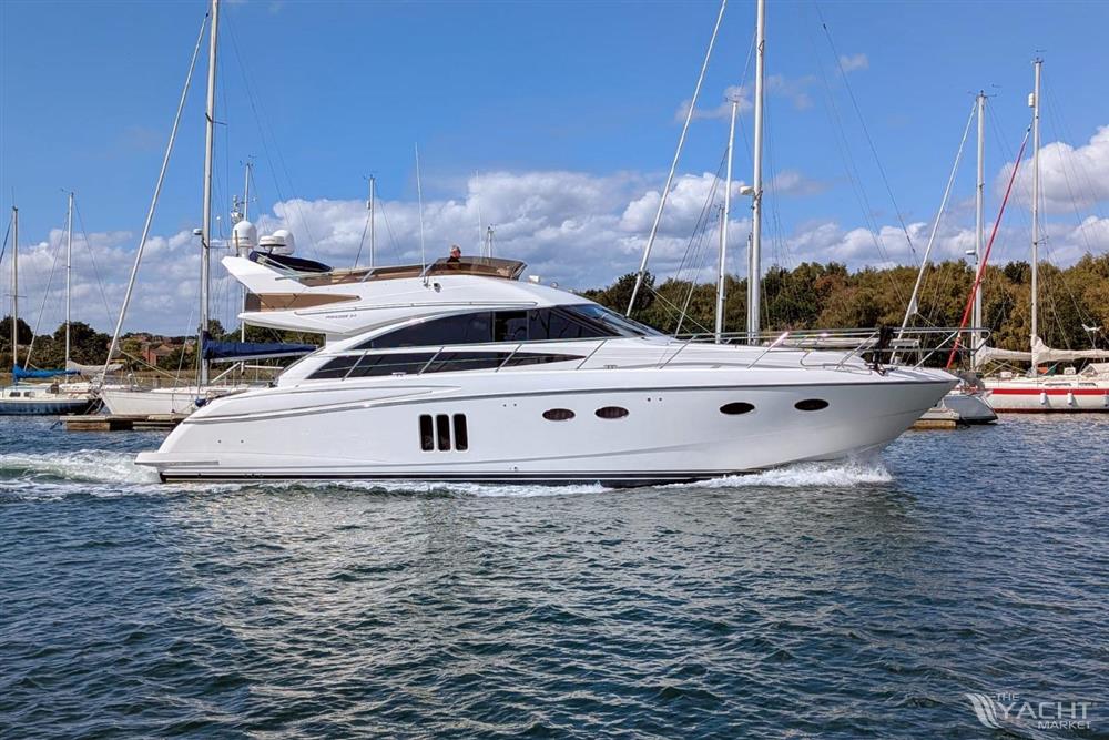 Princess 54 - 2009 Princess 54 yacht cruising in a marina under a clear blue sky.