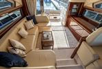 Princess 54 - Luxurious interior of 2009 Princess 54 yacht with beige seating and elegant decor.