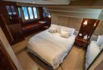 Princess 54 - Luxurious bedroom interior of 2009 Princess 54 yacht with elegant bedding and wood accents.