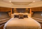 Princess 72 Motor Yacht - Luxurious bedroom interior of 2013 Princess 72 Motor Yacht with elegant bedding and wood accents.