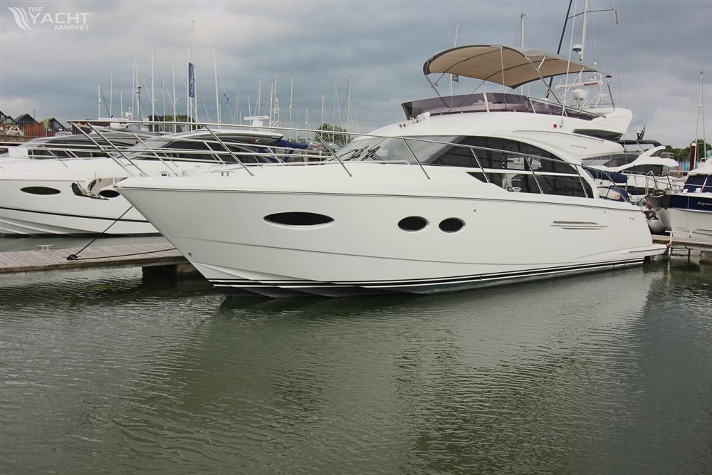 Princess 43 - Luxury 2017 Princess 43 yacht docked at marina under cloudy sky.