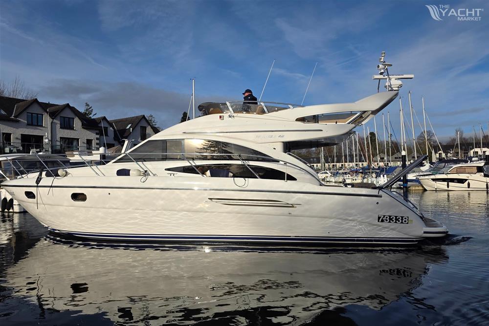 Princess 42 - 2006 Princess 42 Flybridge Motor Yacht docked in a marina, under a clear blue sky.