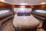 Princess 43 - Luxurious cabin interior of 2016 Princess 43 yacht with plush bedding and elegant wood finishes.