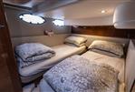 Princess 43 - Cozy twin cabin in 2016 Princess 43 yacht with patterned bedding and soft lighting.