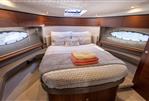 Princess 43 - Luxurious cabin interior of 2018 Princess 43 yacht with cozy bed and elegant decor.