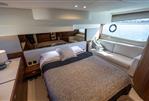 Princess F50 - Luxurious 2022 Princess F50 yacht bedroom with bed, sofa, and ocean view.