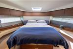 Princess F50 - Luxurious bedroom interior of 2022 Princess F50 yacht with modern design and cozy bedding.