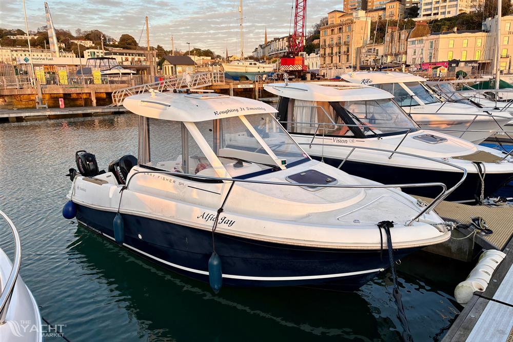 Jeanneau Merry Fisher 585 - 2009 Jeanneau Merry Fisher 585 boat docked in a marina at sunset.