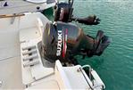 Jeanneau Merry Fisher 585 - 2009 Jeanneau Merry Fisher 585 with Suzuki outboard motor on calm water.
