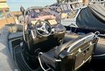Brig Eagle 650 - 2019 Brig Eagle 650 boat interior with steering wheel and seating at a marina.