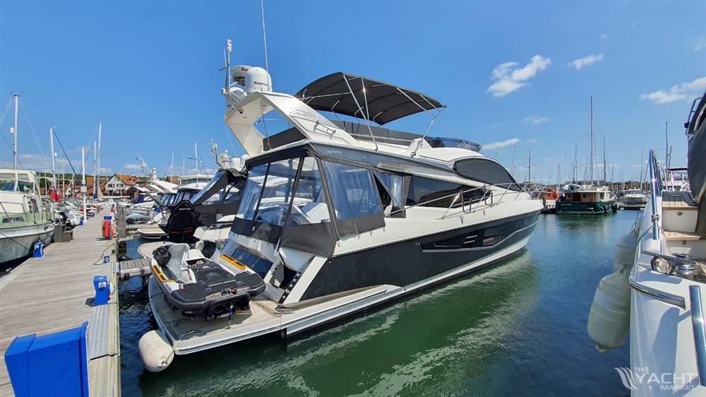 Galeon 550 Fly - 2017 Galeon 550 Fly yacht docked at marina under clear blue sky.