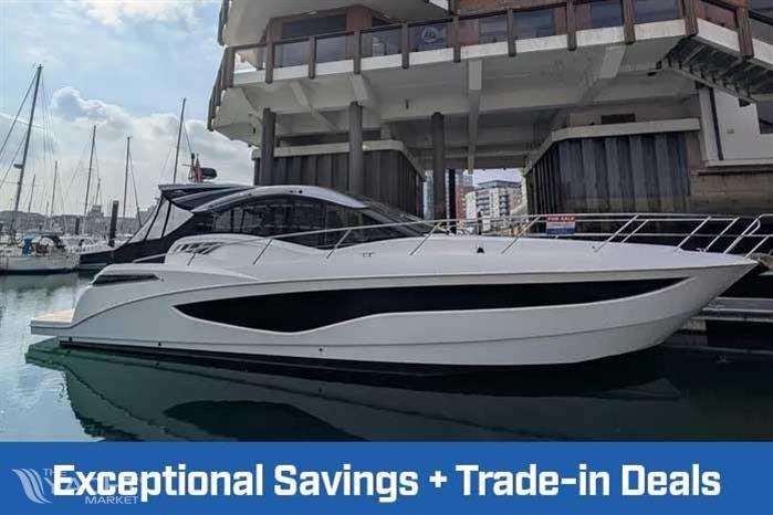 Galeon 485 HTS - 2022 Galeon 485 HTS yacht docked, showcasing sleek design with trade-in deals promotion.