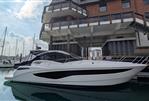 Galeon 485 HTS - 2022 Galeon 485 HTS yacht docked at marina, modern design, clear sky.